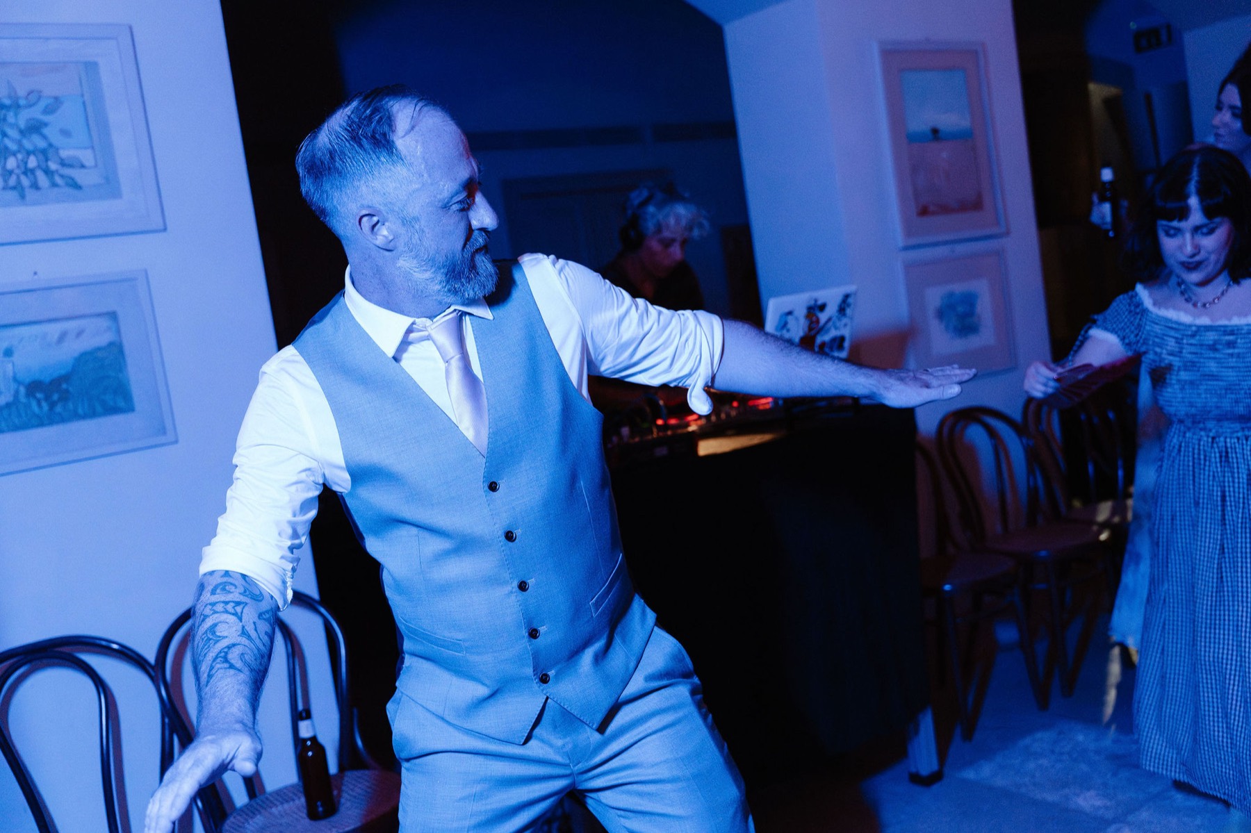 Ken dancing, the shadow of his raised arm across the wall